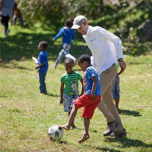 Adrian playing with children